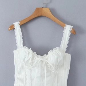 Detailed close-up of the white bustier top featuring lace trim and drawstring bow detail