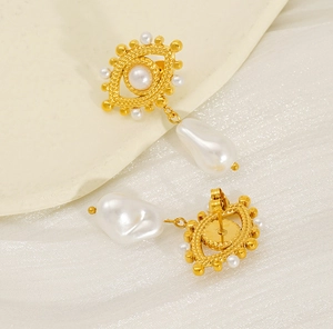 Detail showing 18K gold plated stainless steel evil eye earrings with white pearls