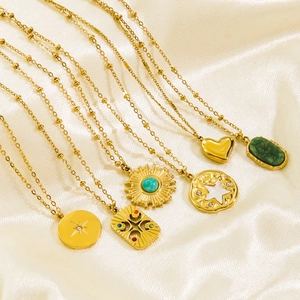 Colliers vintage dorés avec pendentifs en pierre naturelle sur soie blanche plissée