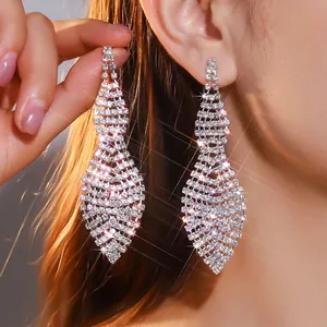 Detailed view of long rhinestone tassel earrings showing diamond mesh shimmer and draping