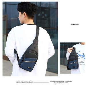 Detail of blue and black business chest bag with multiple zippers and fashion label