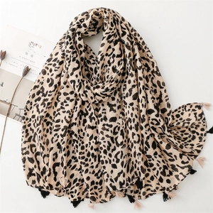 Detail of leopard print scarf featuring soft cotton-linen feel and stylish black fringe edges