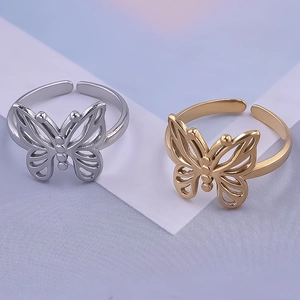 Detail of adjustable butterfly rings in gold and silver finishes with hollow design