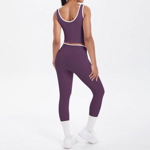 Rear view of dark purple yoga set with white trim showing high elastic seamless fit
