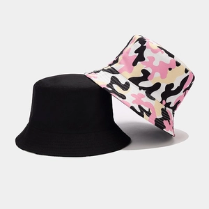 Detail of reversible camouflage and solid black canvas bucket hat with stitching
