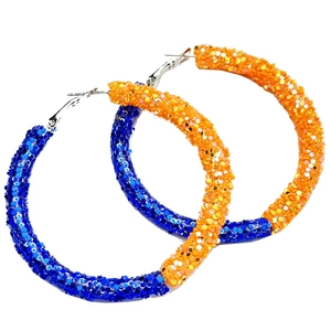Detail view of large hoop earrings with sparkling blue and orange glitter finish