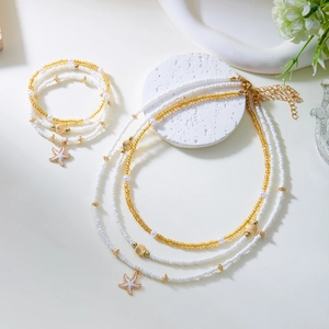 Summer beach jewelry set with white seed beads and golden starfish shell pendants