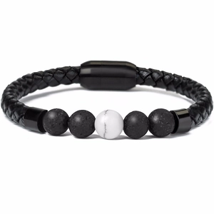 Detail of men's braided leather bracelet with magnetic clasp and tiger eye beads