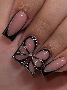 Detail of pink and black French nails with butterfly art and small silver rhinestones