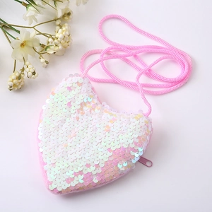 Detail of pink and white gradient heart-shaped sequin crossbody bag with side zipper closure