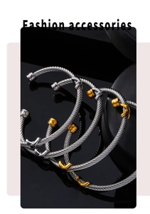 Detail of twisted multi-layer titanium steel cuff bracelet in silver and gold contrast