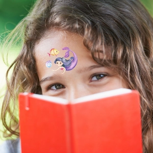 Waterproof glitter mermaid temporary tattoo stickers for kids on a girl's forehead