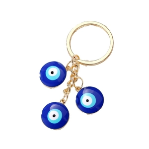 Golden keychain featuring blue evil eye charms with a tassel and heart pendant