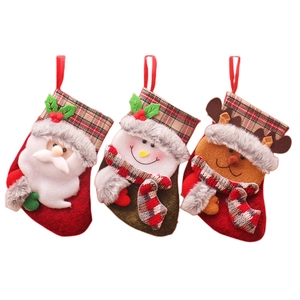 Three plush Christmas stockings with Santa, Snowman and Reindeer in red green plaid