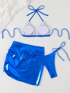 Detail of metallic blue three-piece bikini set with halter top and wrap mini skirt
