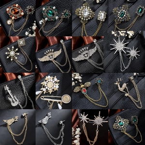 Collection of vintage brooch pin chains featuring stars, crowns, and tassels for suits
