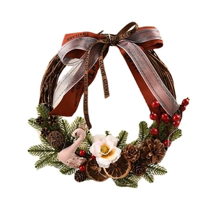 Christmas wreath with pink velvet swan, pine cones, and red berries on rattan ring