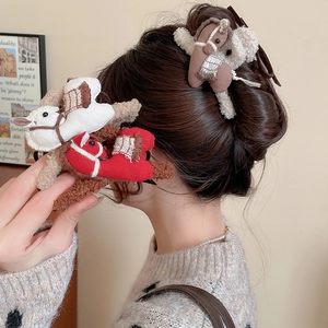 Close-up of plush pony hair claws in red, beige and brown with embroidery details