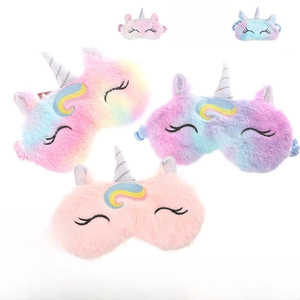 Detail of plush unicorn sleep masks showing soft faux fur and embroidered closed eyes