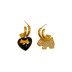 Asymmetric gold puppy and black enamel heart earrings with sparkling cubic zirconia