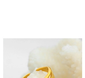 Macro shot of matte gold starfish ring featuring adjustable open band on crystal background