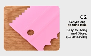 Detail of pink baking scraper with hanging hole and serrated edge on wooden background