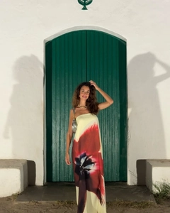Detail view of long strapless tube dress with large red floral print on beige fabric