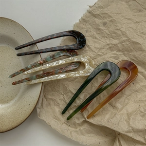 U-shaped acetate hair pins in five classic marble and tortoiseshell patterns for styling