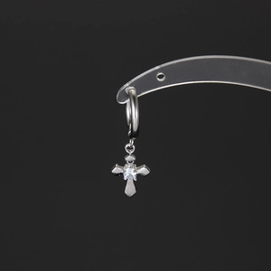 Silver stainless steel cross earrings with center zircon stone on a modern acrylic stand