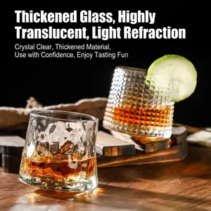 Rocking whiskey glasses with embossed texture and amber liquid on wood surface