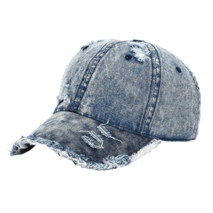 Vintage distressed blue denim baseball cap with ripped details and a worn-out street style