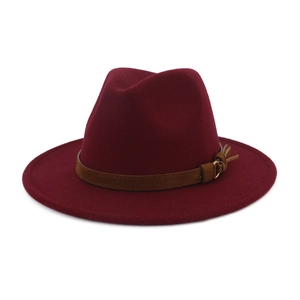 Detail of burgundy wool fedora with brown suede band and gold buckle accent