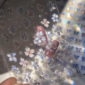 Detail of laser white flower nail stickers on pink nails with holographic light effect