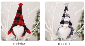 Detail of red and white buffalo plaid Christmas gnomes hanging on white branches