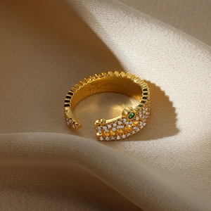 Luxurious gold crocodile open ring with micro-pave crystals and a green gem eye