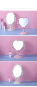 Detail of pink vintage heart-shaped and oval desktop makeup mirrors with baroque carvings