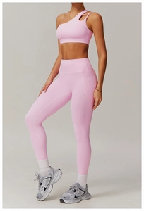Détail d'un ensemble de yoga rose avec brassière asymétrique et legging à taille haute