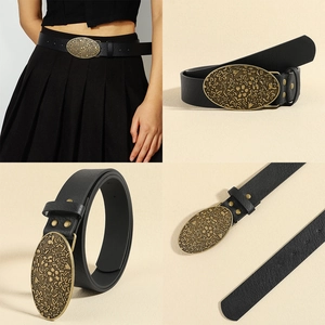 Detail of vintage carved bronze buckle on 3.5cm wide black leather belt for women