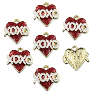 Detail of red glitter heart pendants with gold trim and white XOXO text detail