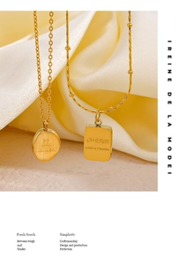 Detailed arrangement of 18K gold plated stainless steel necklaces and earrings on beige fabric