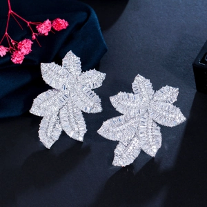 Macro detail of leaf-shaped earring with silver finish and micro-set zircon stones