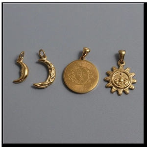 Detailed close-up of golden celestial charms featuring sun and crescent moon designs
