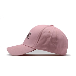 Pink cotton baseball cap with black letter embroidery on the side and curved brim