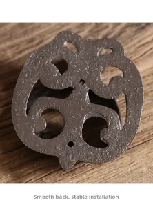 Detail of vintage cast iron door knocker with hollow pattern and flat back for stable mount
