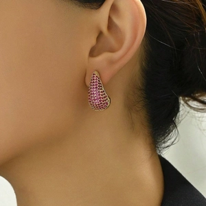 Water drop earrings with micro-pave pink gemstones and a gold finish on female model
