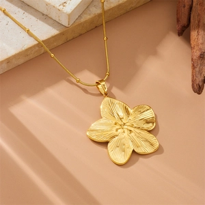 Collier doré vintage avec pendentif fleur texturée et chaîne serpent à perles élégante