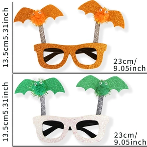 Glittery Halloween bat party glasses in orange and white with fuzzy bat spring decorations