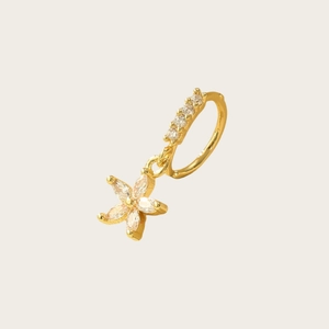 Detailed view of a gold nose ring featuring a white zircon flower pendant and fine stones