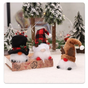Three glowing Christmas gnomes with plaid hats and warm LED lights on a vintage book