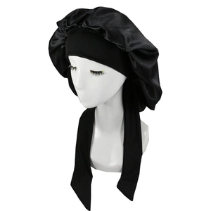 Detail of black satin sleep bonnet with wide elastic band and adjustable ribbons